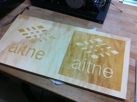 Aitne logo cut into wood with a laser.jpg