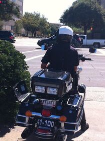 Police officer clocking people on University Dr an.jpg