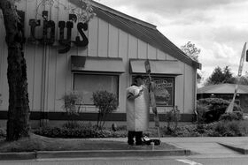 Guy dressed up like a mattress standing outside Ar.jpg