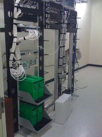 Old networking closet, complete with an old Compaq.jpg